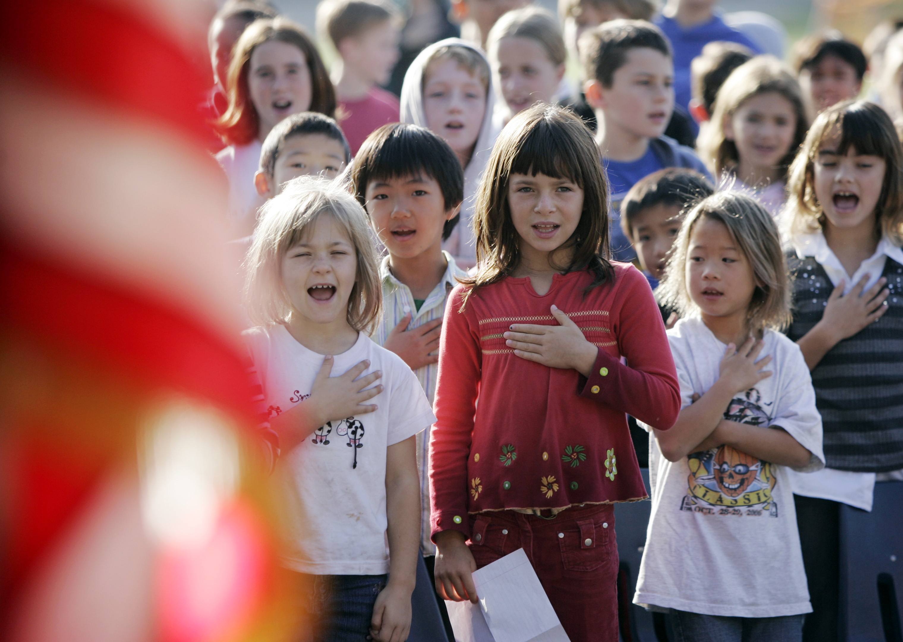 Fairmeadow Elementary School students recite the Pledge of Allegiance during a school assembly in Palo Alto, Calif., Monday, Nov. 5, 2007. Micheal Newdow, a Sacramento doctor and lawyer, is seeking to remove the words "under God" from the Pledge of Allegiance and U.S. currency. He is taking his arguments back to a federal appeals court on Tuesday, Dec. 4. (AP Photo/Paul Sakuma)